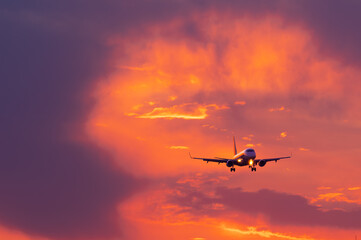  plane lands on the runway during the setting sun