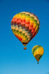 Colorful Hot Air Balloons Ascending in Clear Blue Sky