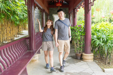 A Chinese Malaysian couple in their 30s spends time in a Chinese garden in Kuala Lumpur, Malaysia. A sunny afternoon in June 2024.