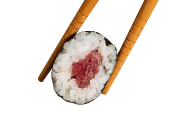 Chopsticks holding delicious tuna sushi roll with rice and seaweed on transparent background © Miquel