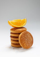 stack of round orange cookies on white background, copy space