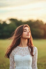 Fototapeta premium Young woman with long flowing hair enjoying the outdoors on a sunny day
