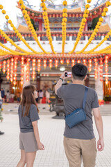 June 2024. A Chinese Malaysian couple in their 30s spends time at a famous Chinese temple popular with tourists in Kuala Lumpur, Malaysia.