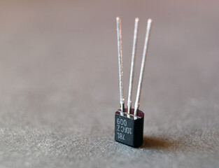 Close up of a transistor. Isolated single semiconductor electronic component.
