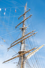 A group of colorful rigging and ropes is connected to the ship's mast to support and control the sails. Phuket, Thailand.