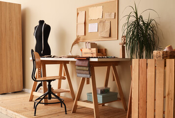 Interior of stylish atelier with tailor's workplace