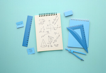 Stationery calculator ruler calculator and school cheat sheets on coloured background. Concept of...