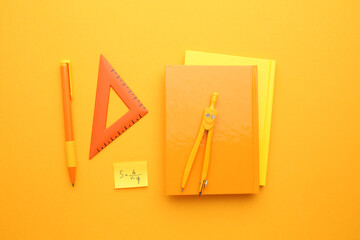 Stationery calculator ruler calculator and school cheat sheets on coloured background. Concept of...