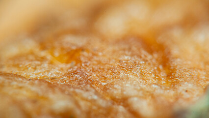 A close-up of orange marmalade, glistening with a layer of sugar