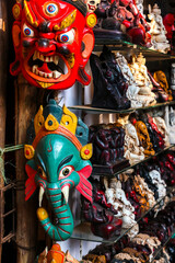 Colorful masks and statuettes for sale in the street shop. Shopping in Arambol, Goa, India.