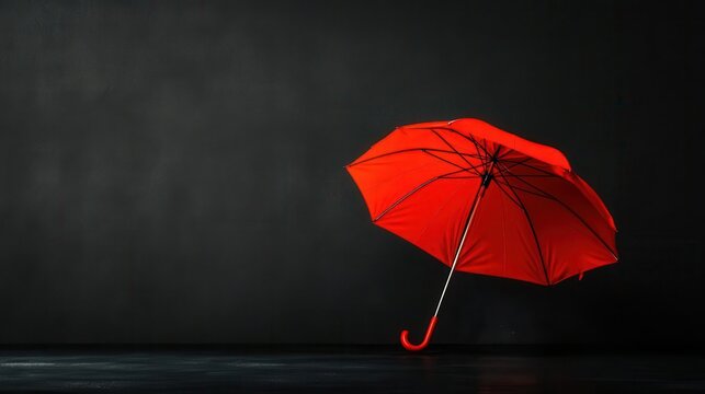 Red umbrella against a grey background, sleek and minimalist design