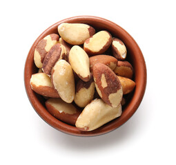 Bowl with tasty Brazil nuts on white background