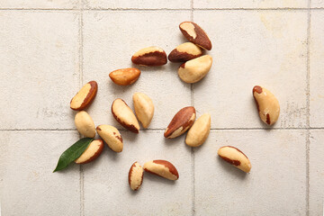 Tasty Brazil nuts on white tile background