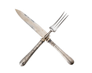 antique silver cutlery. knife and fork crossed. isolated white background