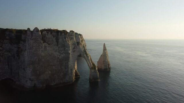 Exploring the stunning cliffs of Etretat during a golden sunset