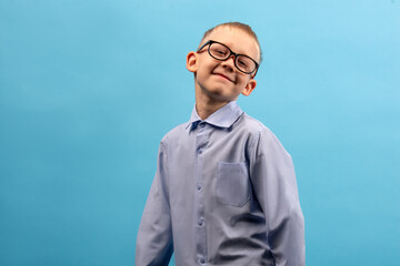 Child 8-9 years old on a blue background. Portrait of a boy with different facial expressions.
