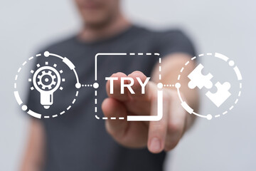 Man using virtual touch screen presses word: TRY. Try it now or try again business slogan concept....