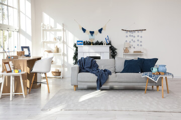 Interior of festive living room with grey sofa and decorations for Hanukkah celebration