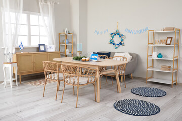 Interior of festive living room with dining table and decorations for Hanukkah celebration