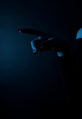 Silhouette of female hand on dark background, close-up,