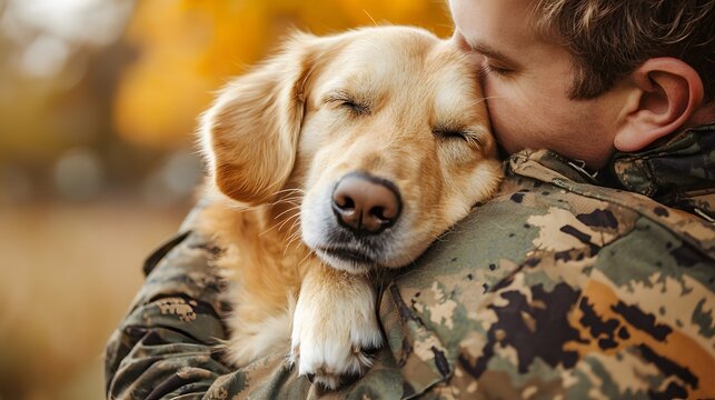 Military veteran outdoors with golden retriever puppy outdoors. Therapy dogs, emotional well-being and National Pets for Veterans Day
