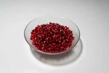 Pomegranate seeds in a glass bowl