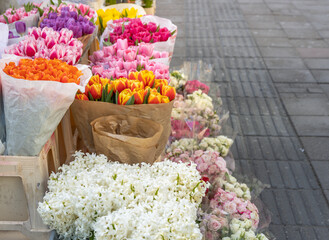 Flower stand with a variety of flowers including white and pink