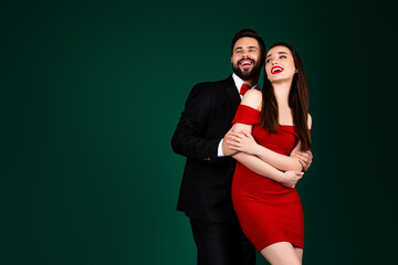 Photo of stunning young girl guy couple hugging look empty space wear trendy fancy classy outfit isolated on green color background