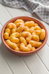 Puffed crispy Peanut flips in bowl on white table.