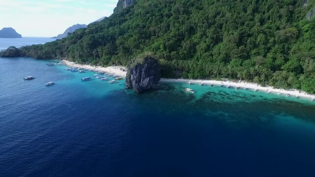 Seven Commandos and Papaya Beach in Palawan, Sightseeing Place. Tour A in El Nido, Philippines. Serene white sand beach with clear turquoise water, palm trees rock formations in Background. Drone