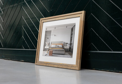 PSD template of Empty Wooden Frame Leaning Against a Dark Green Wall in a Well-Lit Interior Space. Side view