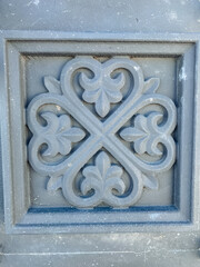 A gray square that prominently features a striking, intricate, and beautiful floral design on its surface, showcasing the depth of artistic creativity and meticulous attention to detail