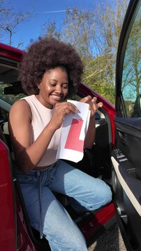 Hampshire England UK. 01.11.2024. Video.  Happy learner driver passes driving test and tears up her L plate