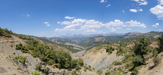 Permet, Albania - August 15 2024: Remote and rugged mountainous landscape along the challenging SH75 road between Berat and Permet, showcasing the wild beauty of Albania's dramatic terrain. Summer.
