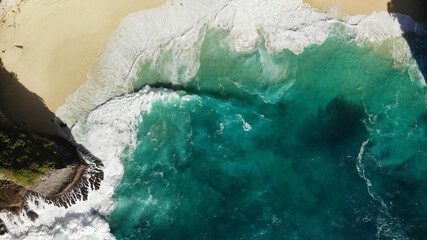 Top view beach with waves and rock