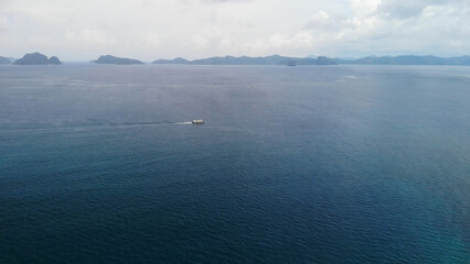 Motor boat sailing in the ocean, view from above