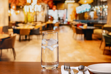 Glass of water on restaurant table. Clean drinking water, water conservation and restrictions concept.