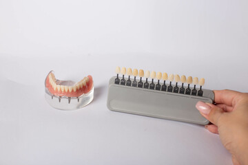render of mandibular prosthesis all on 4 system supported by implants over white background