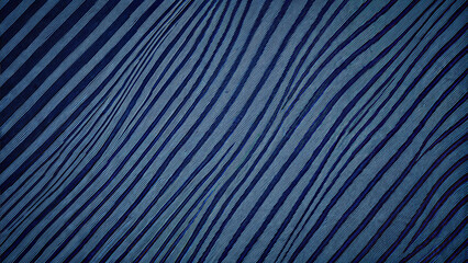 Fototapeta premium Textured background of worn old denim fabric with stripes, dark blue tones, copy space