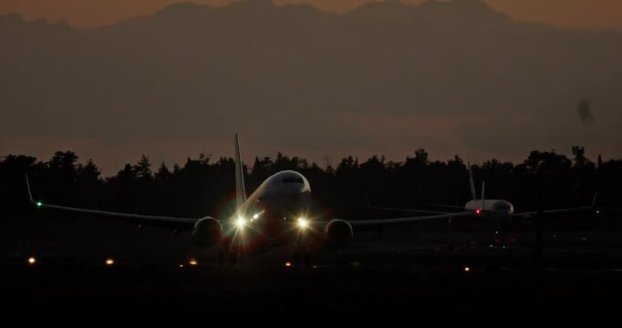 Slow-motion video of a plane taking off from the runway at night. Travel and tourism concept. High quality 4k footage
