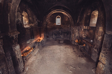 Interior of a temple in Armenia illuminated by candles