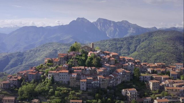 Mountain Village in Liguria: Drone View of Italy&rsquo;s Green Hills and Mountain Panorama on a Bright Day with Blue Sky &ndash; Drone Flyover Dolly Out
