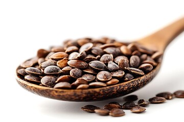 Obraz premium Watermelon seeds in a wooden spoon on white background