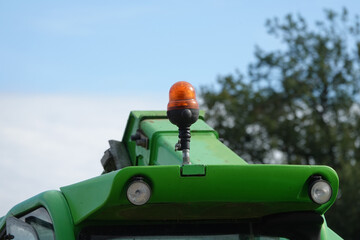 Signal orange dome LED light at tractor