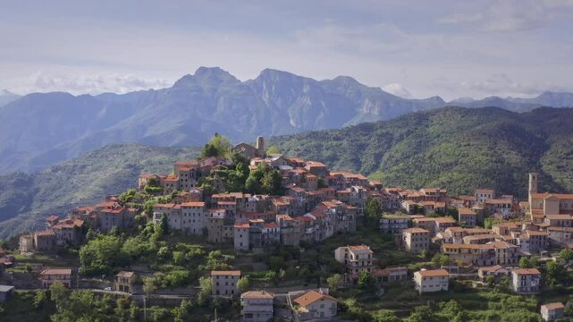 Mountain Village in Liguria: Drone View of Italy&rsquo;s Green Hills and Mountain Panorama on a Bright Day with Blue Sky &ndash; Wide Shot Drone Dolly in
