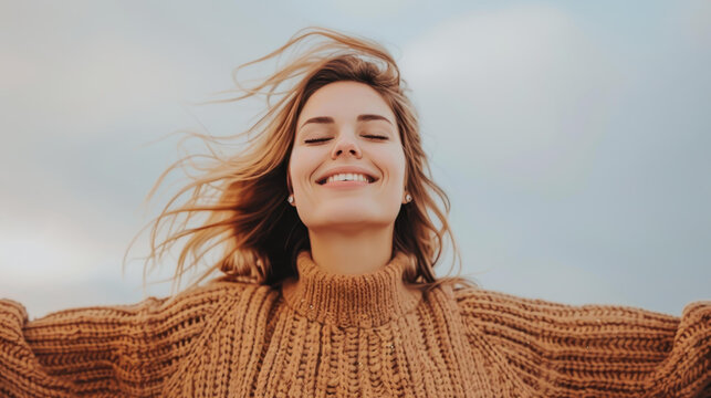 A joyful woman embraces the sky, arms wide open, celebrating the bliss of life and freedom in natures beauty.