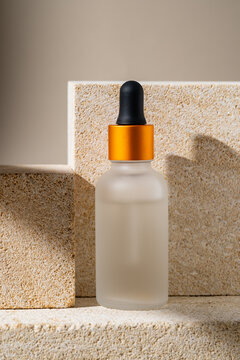 Minimalist Cosmetic Serum Bottle on Stone Podium