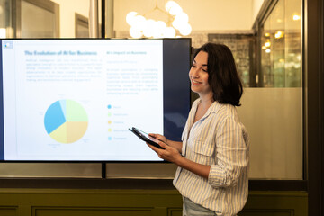 Young professional presenting data in a modern coworking space