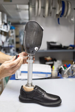 Technician Adjusting Prosthetic Leg in Orthopedic Supply Store