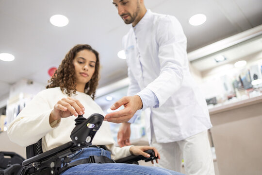 Professional assistance and modern wheelchairs in orthopedic store